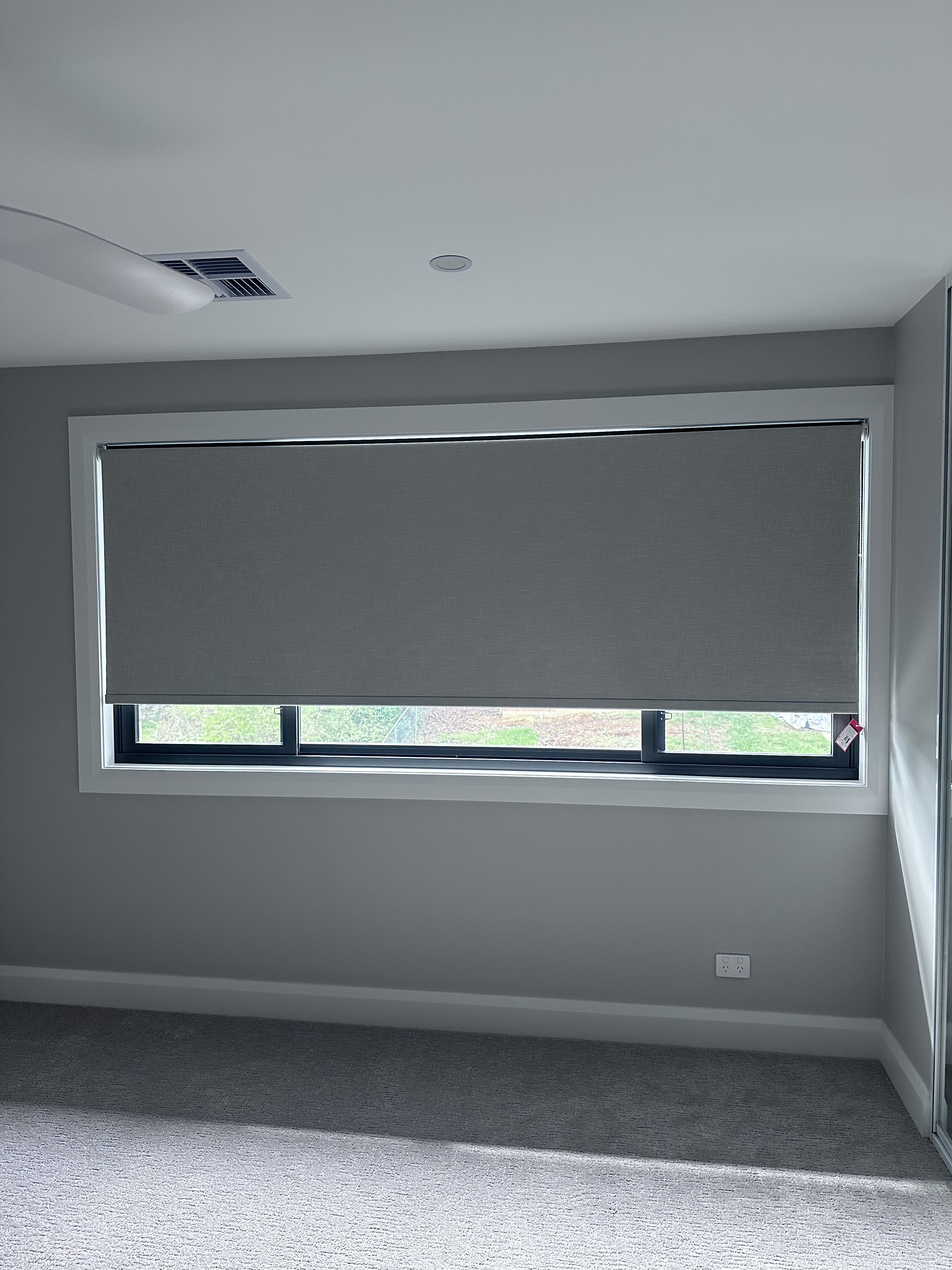 Bedroom with dual roller blinds