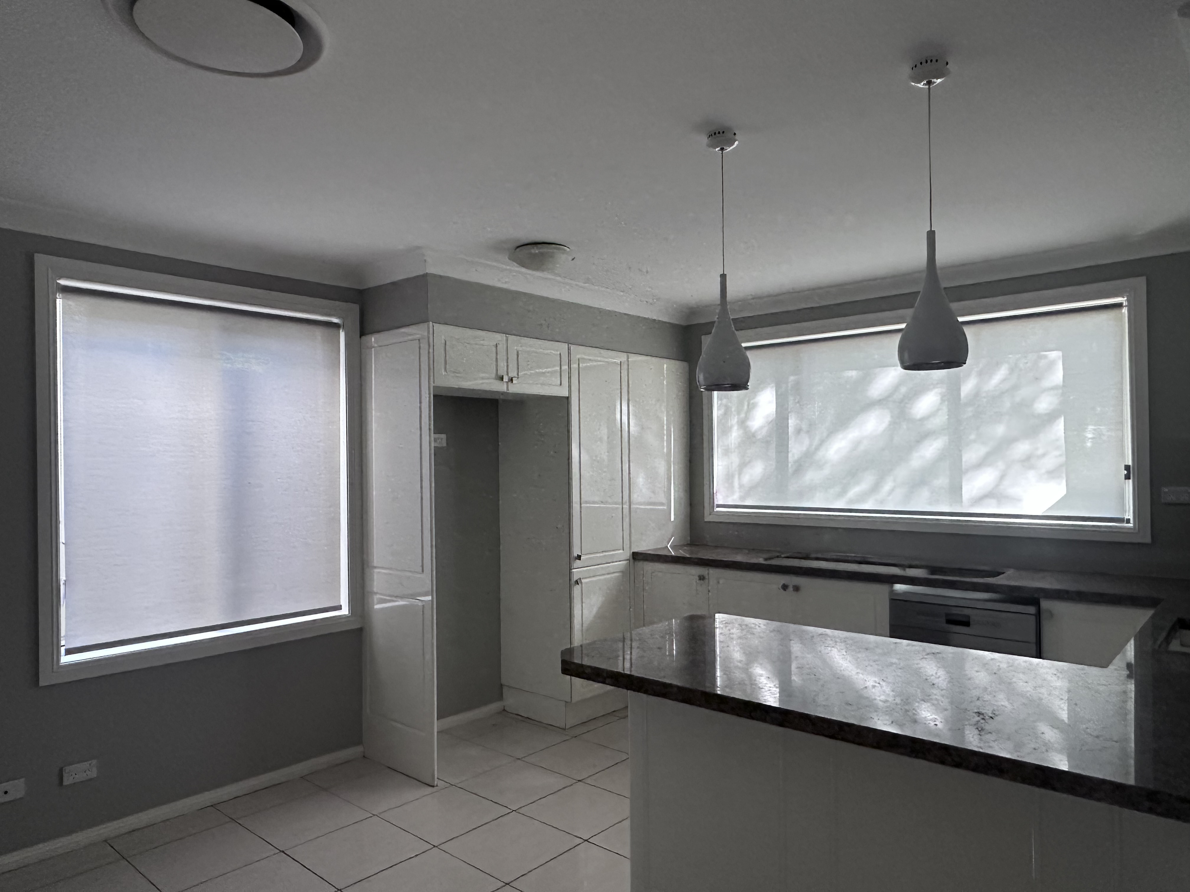 Bedroom with dual roller blinds
